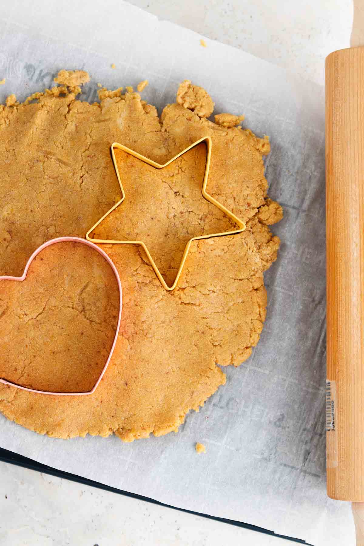 Cookies cut out on a baking sheet.