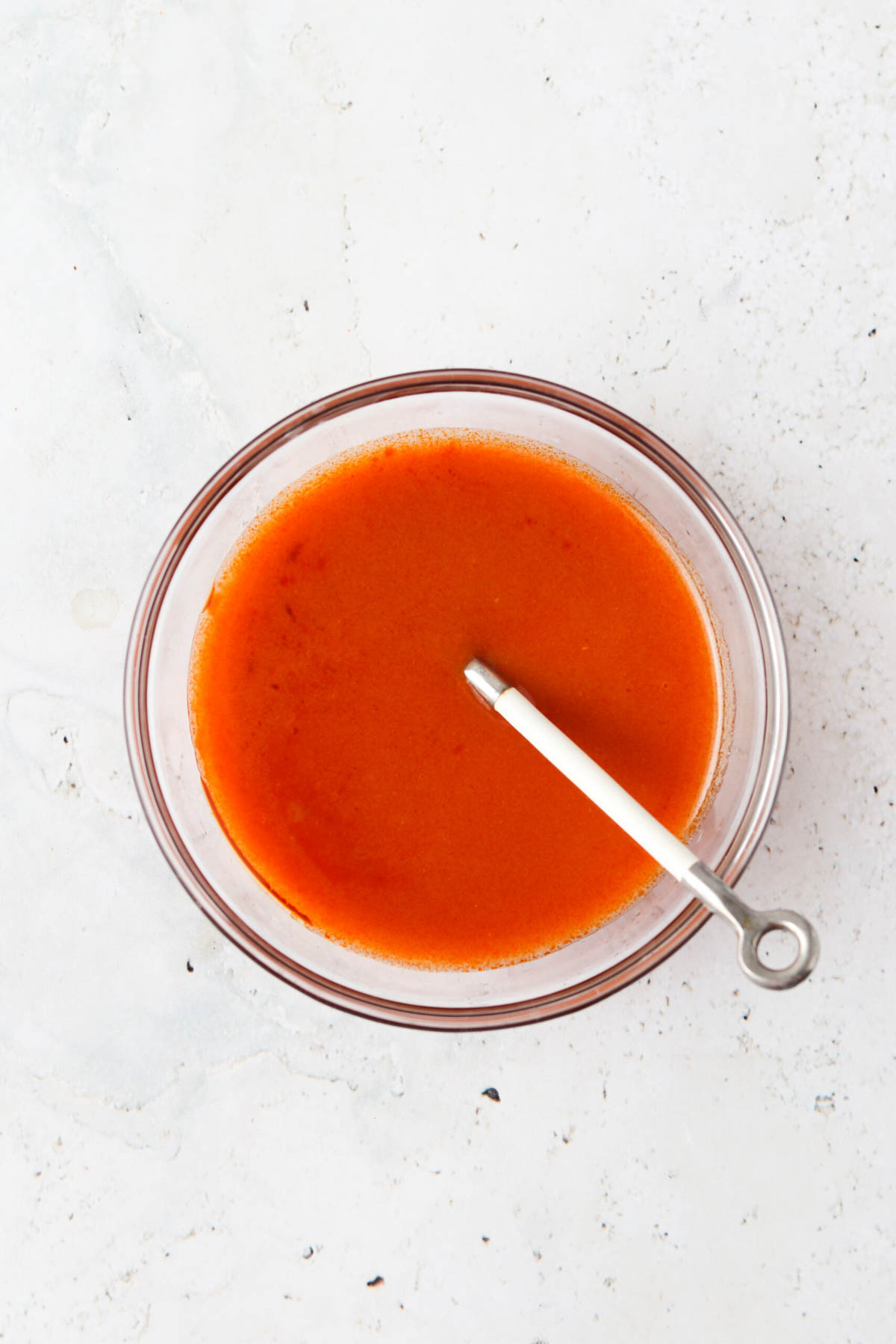 Buffalo sauce for shrimp tacos in a small bowl.