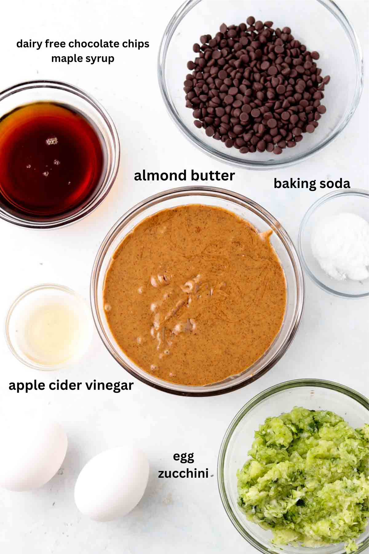 Gluten free zucchini muffin ingredients in small glass bowls.