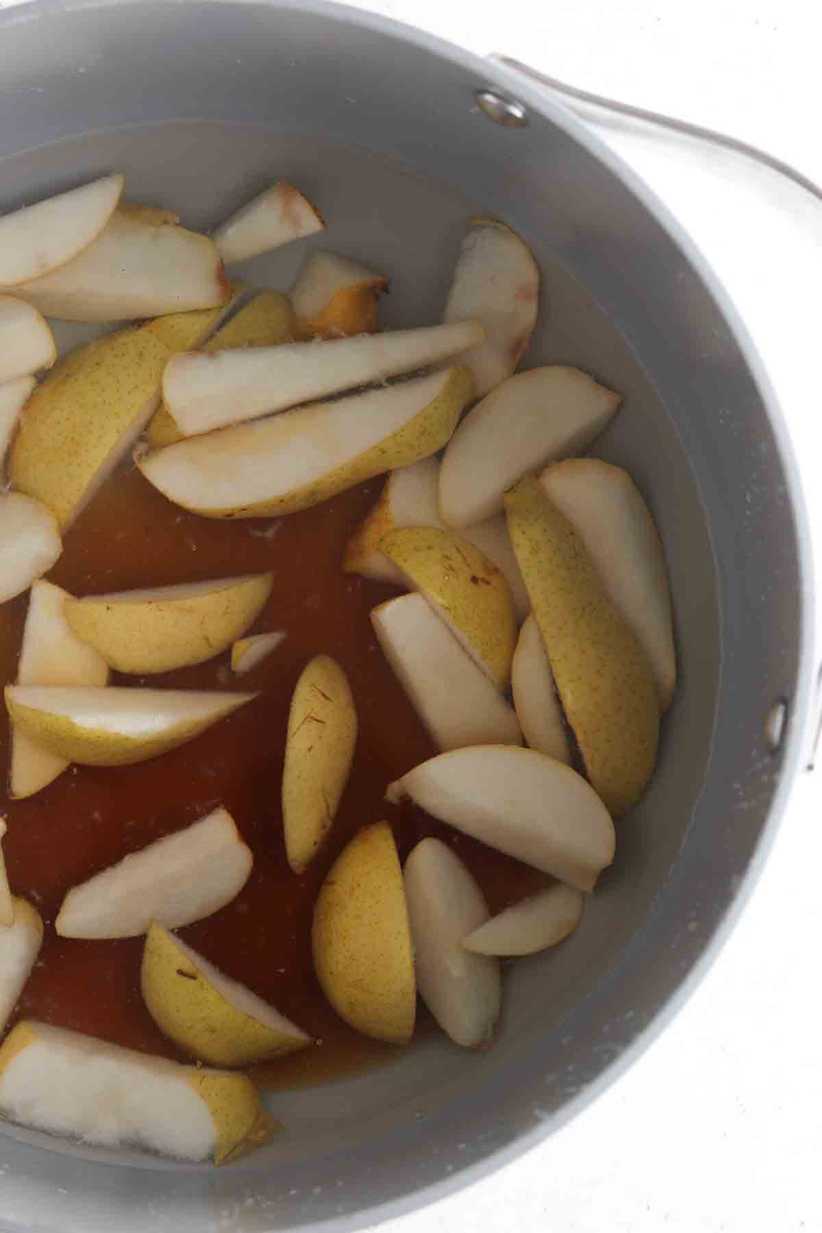 Pears, honey and water in a large pot. 