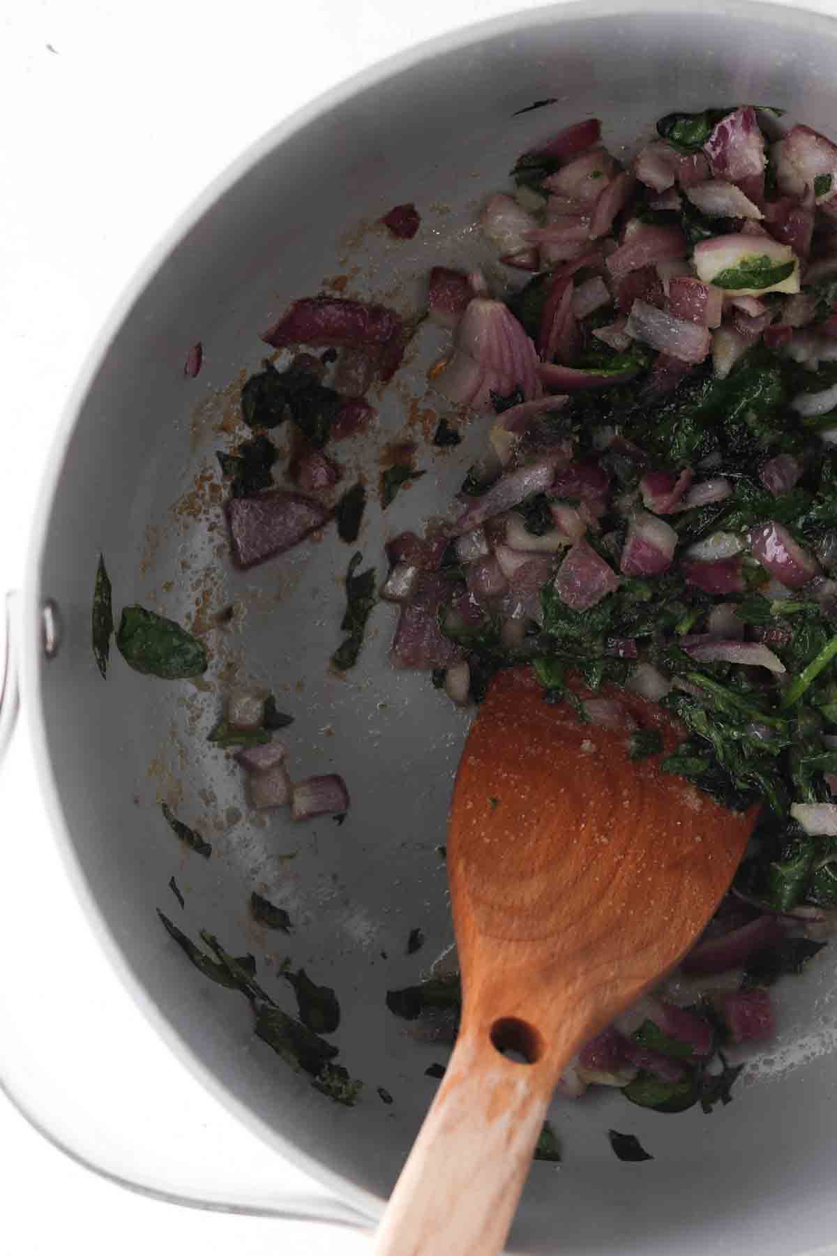 Onions, spices, avocado oil, and spinach in a large soup pot. 