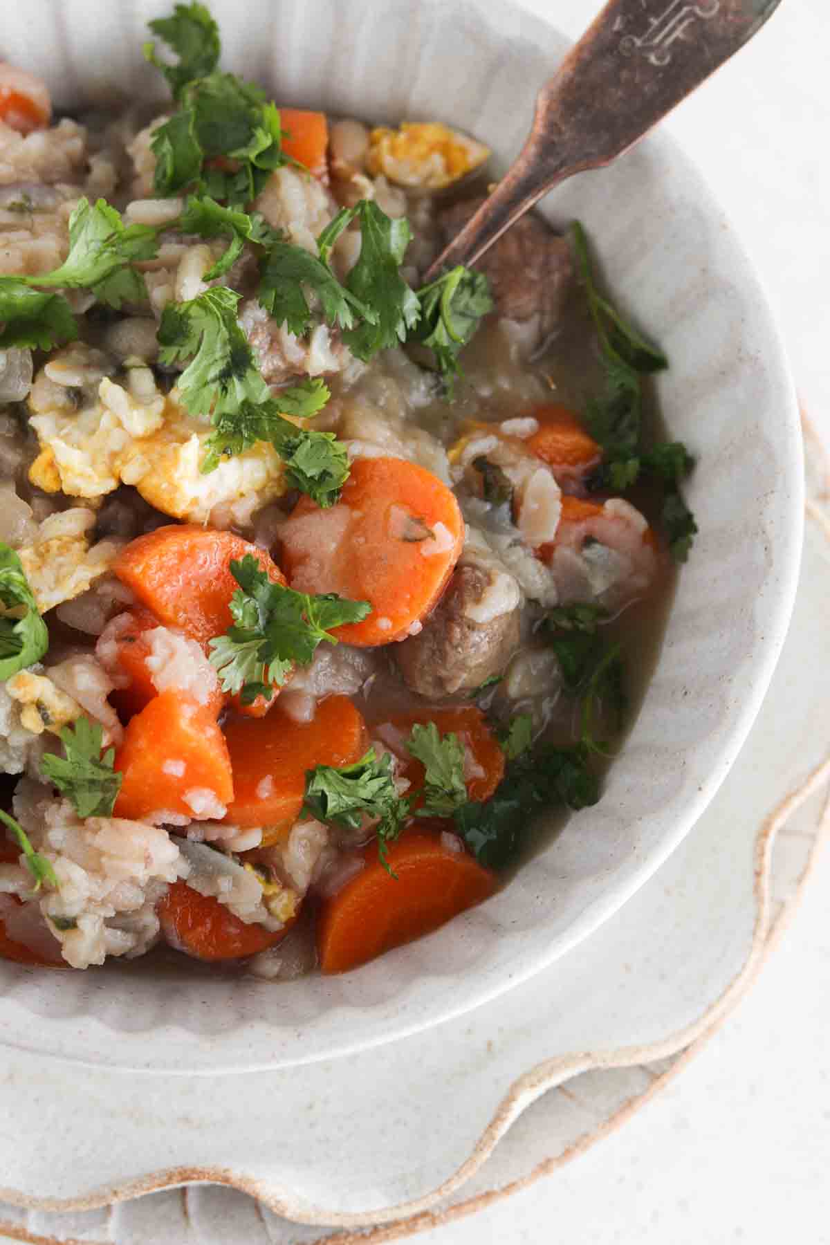 Italian wedding soup in a bowl with fresh parsley sprinkled on top.