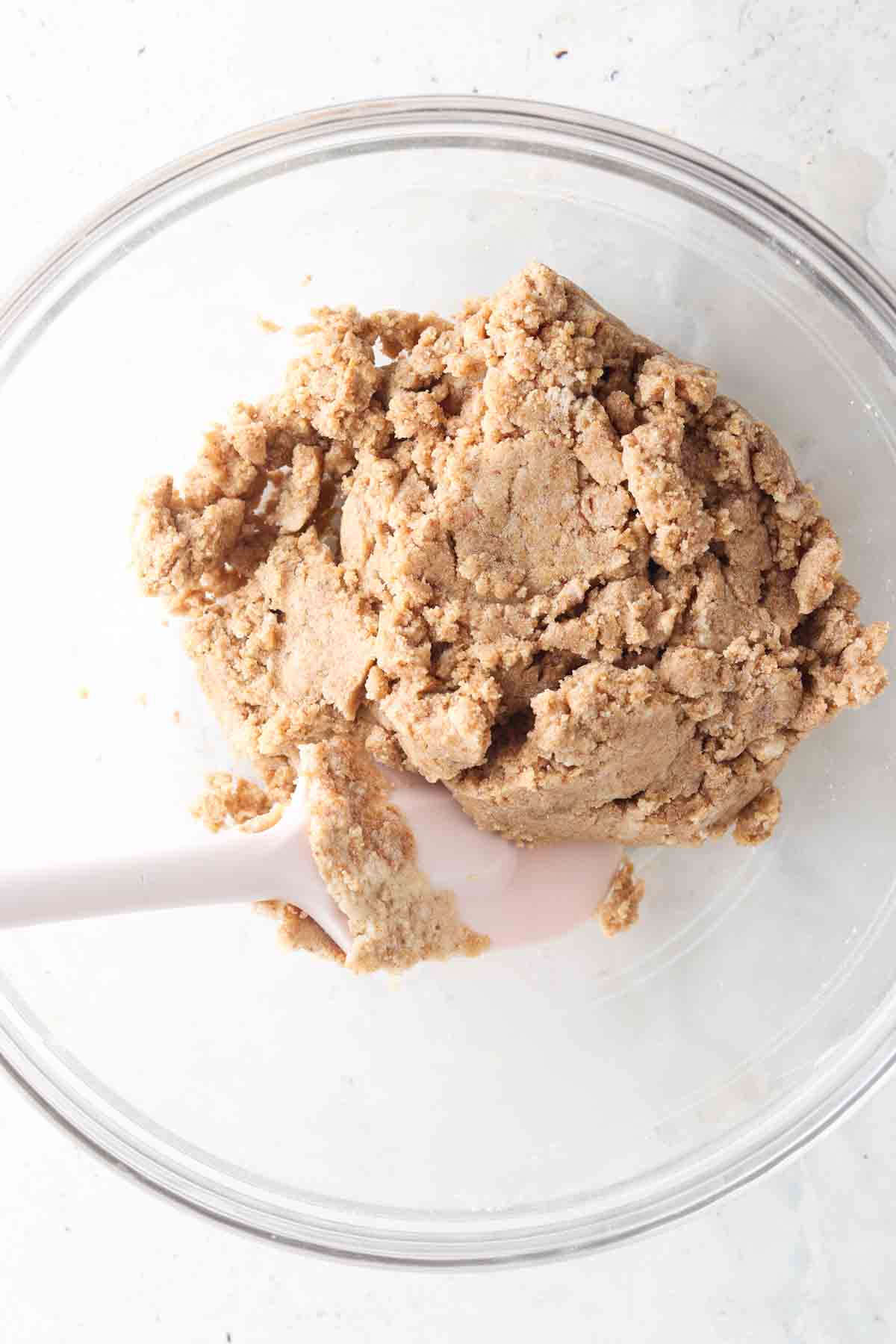 Wet and dry cookie ingredients mixed together in a large bowl. 