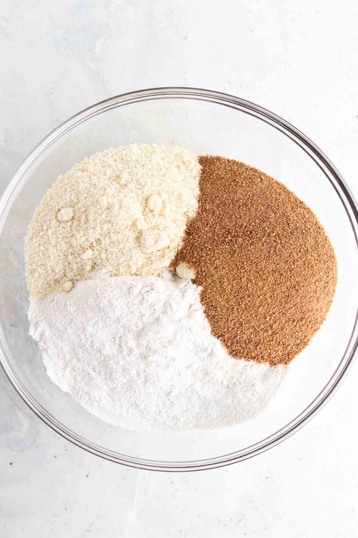 Dry cookie ingredients in a glass bowl.