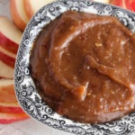 Vegan fruit dip on a plate with apple slices.