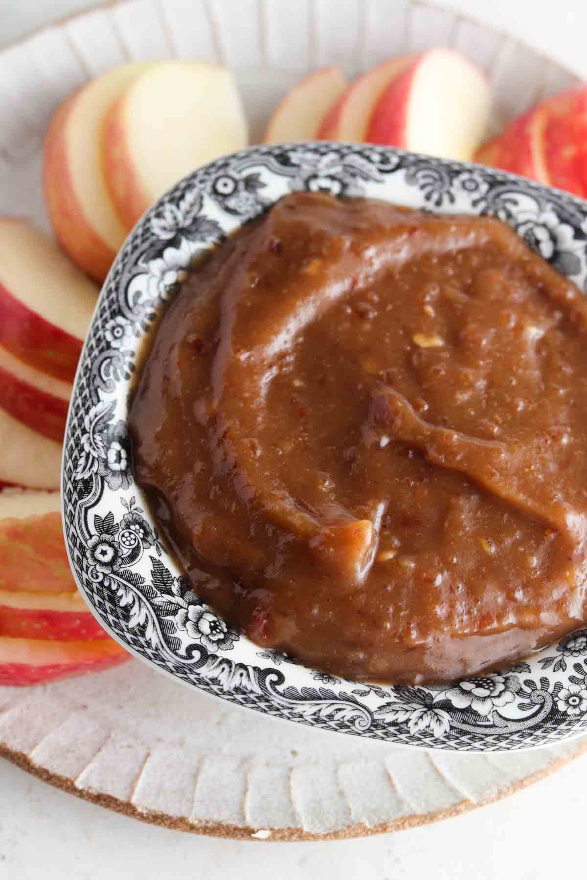 Vegan fruit dip on a plate with apple slices.