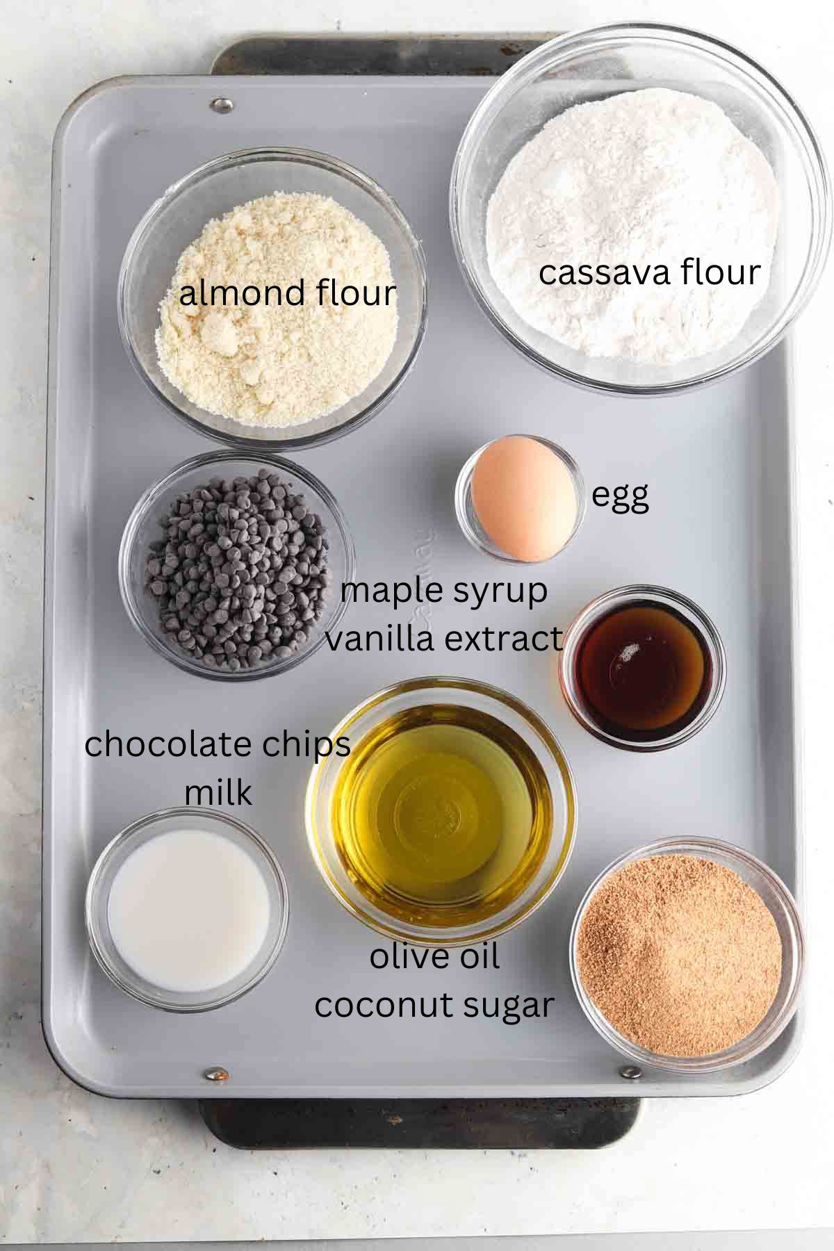 Gluten Free Thumbprint Cookie ingredients laid out on a baking sheet in glass bowls. 