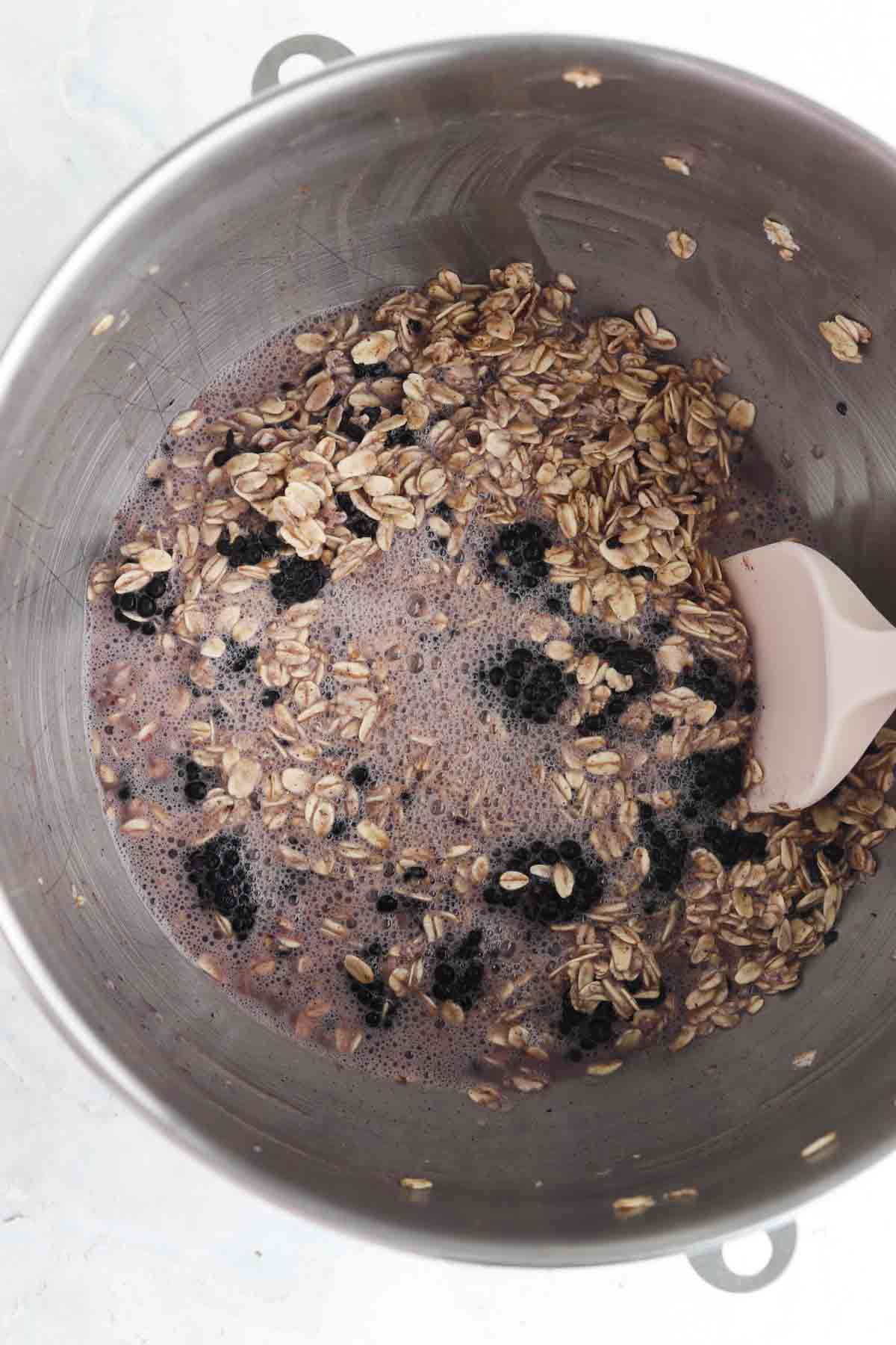 Mixed blackberry oatmeal ingredients in a bowl. 