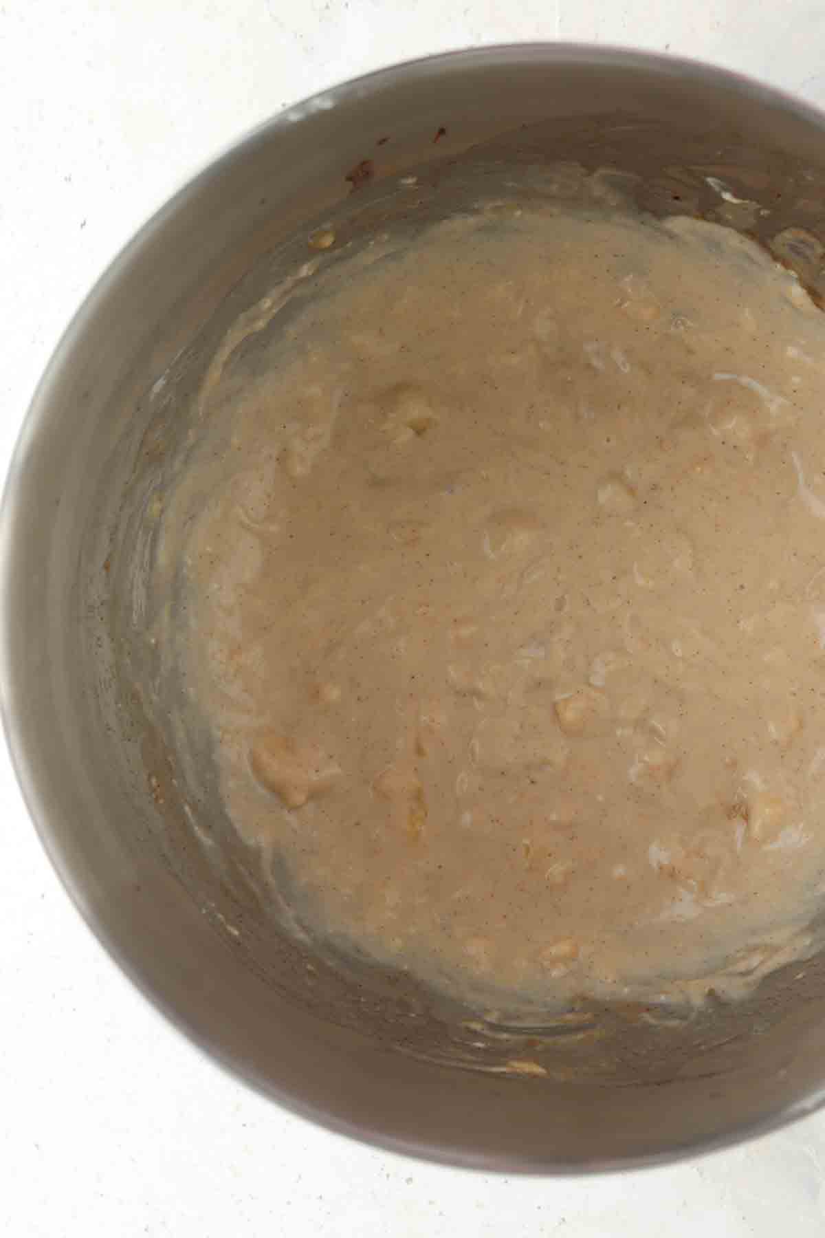 Banana cream cheese frosting in a large mixing bowl.