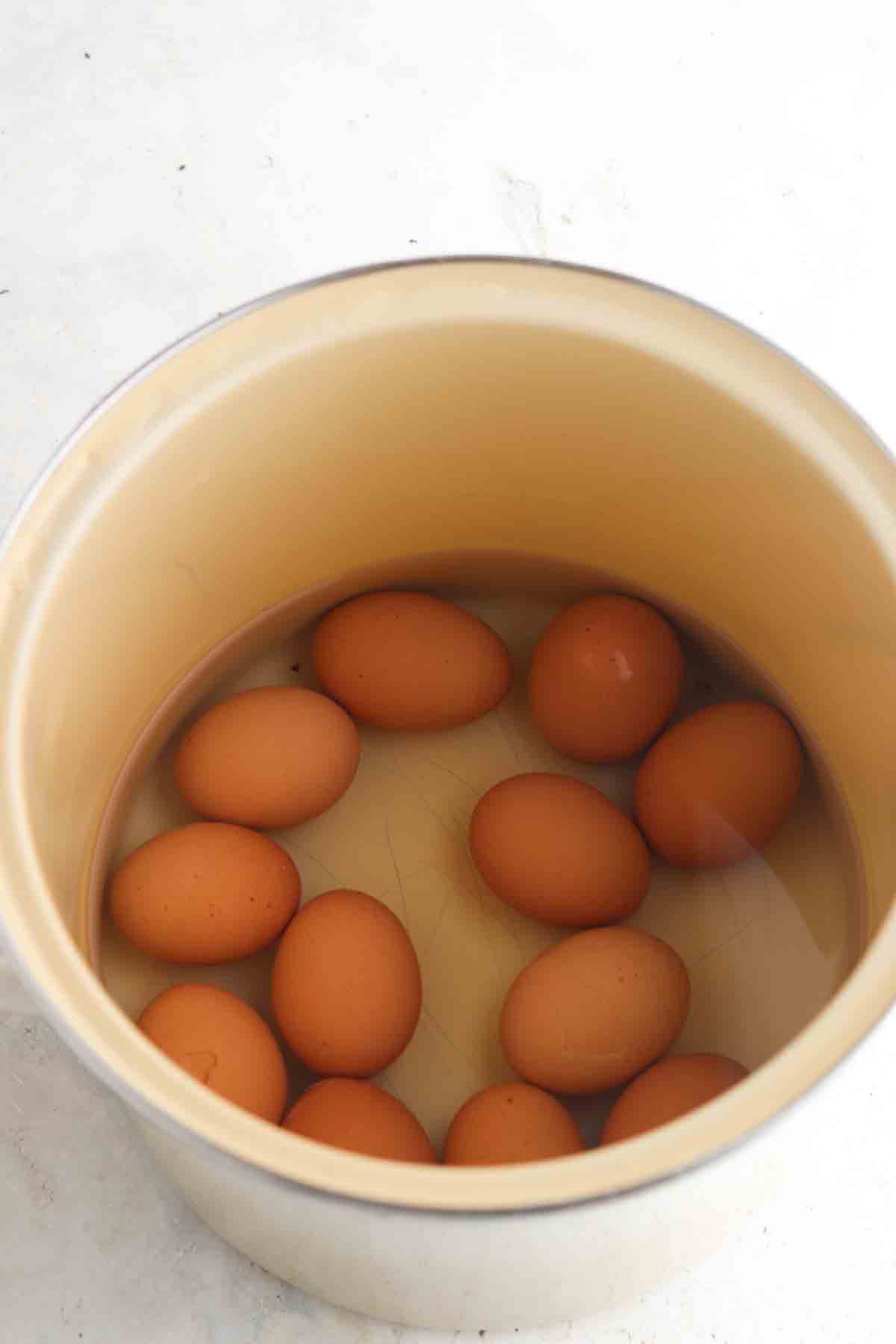 Eggs in a pot of boiling water.