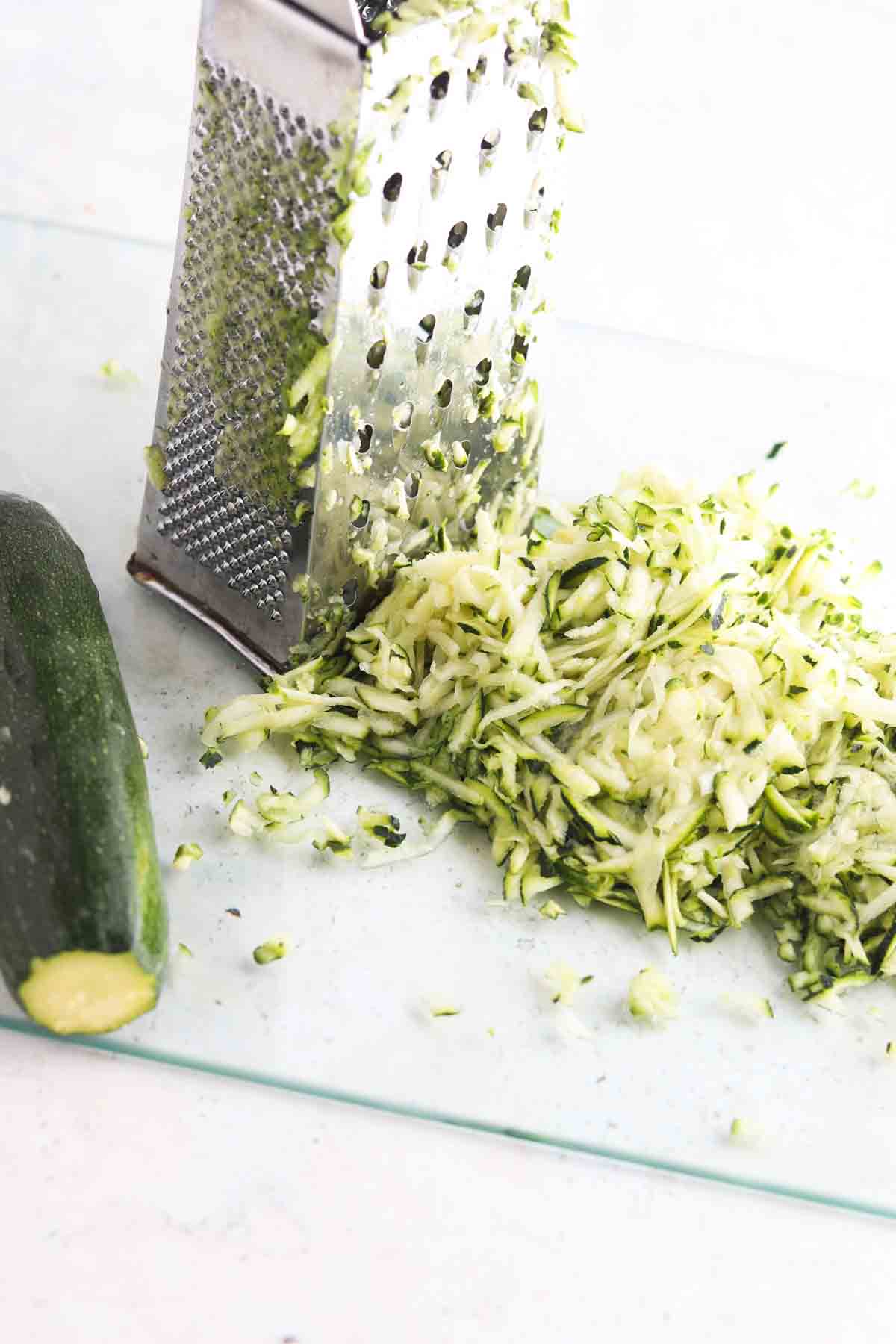 Grated zucchini on a cutting board. 